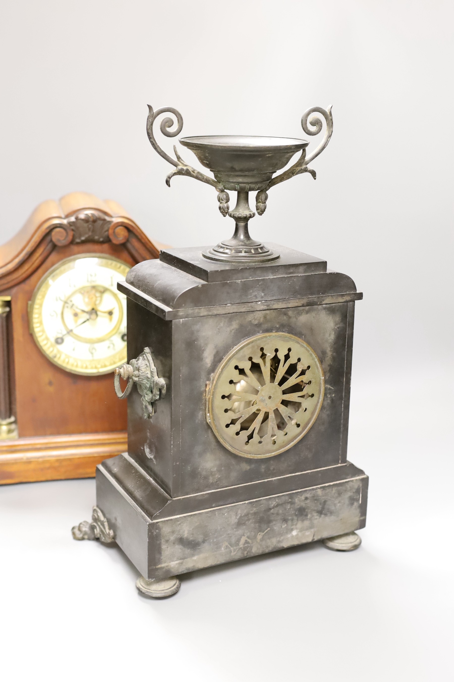 A 19th century slate urn mantel clock with lion feet, together with an American column mantle clock, tallest 41cm